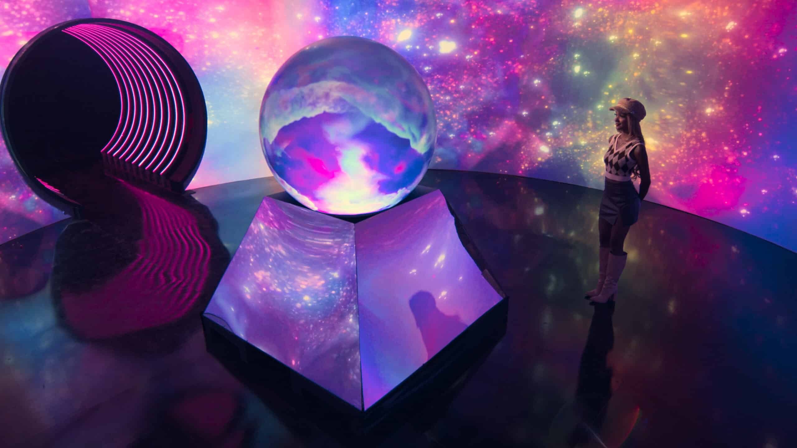 A young woman looks at the PufferSphere on Amazon Prime's Cosmic Love